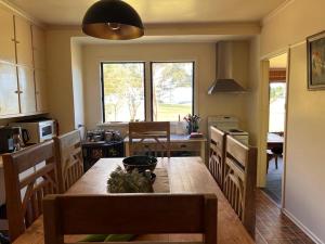 a kitchen with a wooden table and a dining room at Twelve Apostles Ocean View in Princetown