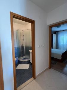 a room with a bathroom with a shower and a toilet at Apartments and Rooms Jasna in Hvar
