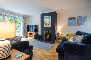 a living room with a blue couch and a fireplace at Tall Ships, Charlestown - two ticks from the harbour in Charlestown