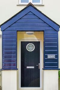 a blue outhouse with a door in front of it at Tall Ships, Charlestown - two ticks from the harbour in Charlestown