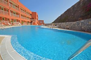 a large swimming pool in front of a building at CASA LOTTA in Costa Calma