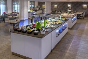 a large kitchen filled with lots of different types of food at Hotel Acqua in Salou