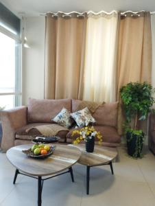 a living room with a couch and two tables at Ten Steps To The sea 4BR And Balcony in Bat Yam