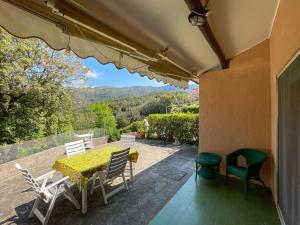 a table and chairs on a patio with a view at Appartamento Il Faro 2 in Rio nellʼElba