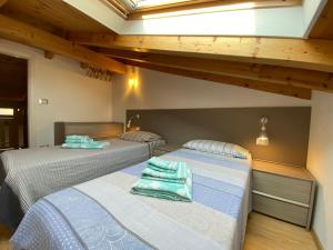 two beds sitting in a room withwered at Apartments Bea in Lovran