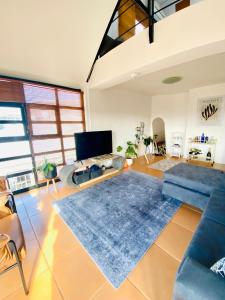 a living room with a blue couch and a blue rug at Loft 2 - De Waterkant in Cape Town