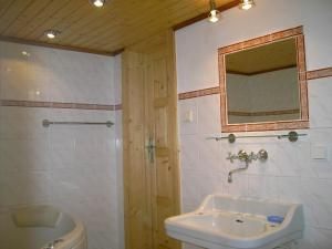 a bathroom with a sink and a toilet and a mirror at Chalet Tatranec in Vyšné Hágy