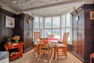 a dining room with a table and chairs and a window at Potters Mooring Hotel in Teignmouth +29 photos