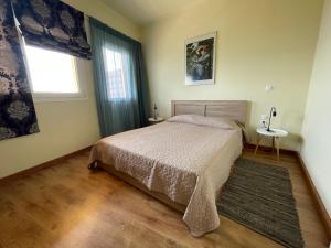 a bedroom with a bed and a window at Village House Kalypso in Paleokastritsa
