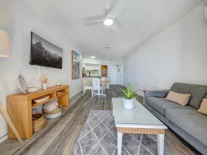 a living room with a couch and a table at Seaside Stays Marcoola Beach Apartment 1 Bedroom in Marcoola