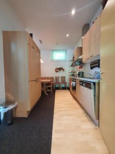 a kitchen with wooden cabinets and a wooden floor at Höss-Alpin-Lodge in Hinterstoder