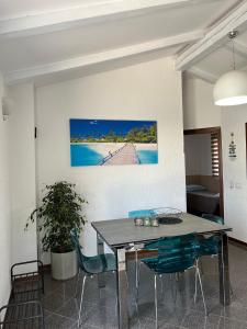 a dining room table with chairs and a painting on the wall at Holiday Home Rosa in Gedići