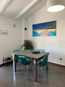 a dining room table with chairs and a painting on the wall at Holiday Home Rosa in Gedići