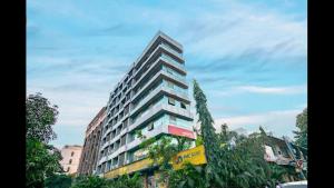 a tall building with a yellow sign in front of it at THE BEST HOTEL MUMBAI in Mumbai