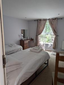 a bedroom with two beds and a window at Barley Sheaf, Old Bridge Street EN SUITE ROOMS, ROOM ONLY in Truro +48 photos