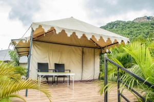 a tent with chairs and a table in it at Eco Adventure Resorts Khhairabera in Bāghmundi