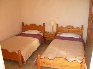 a bedroom with two beds and a lamp in it at VASILIKI SeaMemories in Barbati