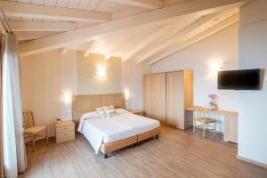 Postel nebo postele na pokoji v ubytování Hotel Pineta Campi