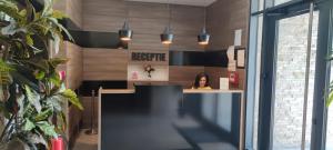 a woman sitting at a desk in an office at Hotel Excellence in Bucharest