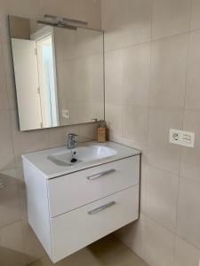 a bathroom with a white sink and a mirror at SEA&RELAX in Puerto del Carmen