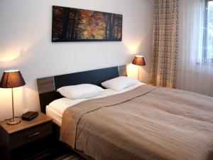 a bedroom with a large bed with two pillows at Holiday Home Vesenjak in Maribor