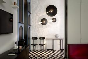 a living room with a black and white checkered floor at CocoMorghen Apartment in Naples