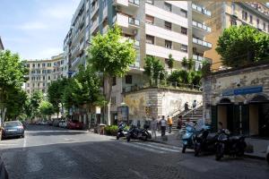 a group of motorcycles parked on a city street at CocoMorghen Apartment in Naples +25 photos