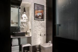 a bathroom with a sink and a toilet at CocoMorghen Apartment in Naples