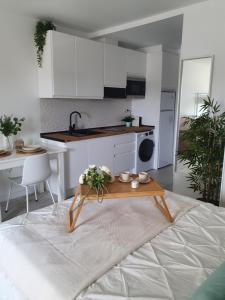 a kitchen with white cabinets and a table in a room at Benalbeach Playa in Benalmádena +74 photos