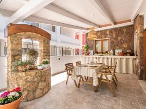 a kitchen and dining room with a table and chairs at Villa Iole Apartment in Carloforte