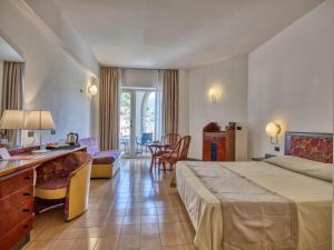 Postel nebo postele na pokoji v ubytování Hotel Olimpo le Terrazze