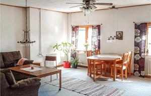 a living room with a table and a couch at Awesome Apartment In Torsker With Wifi And 3 Bedrooms in Stjärnsund