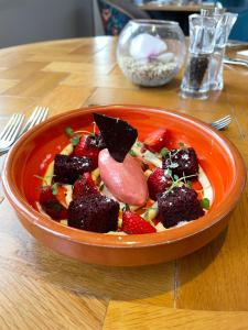 an orange bowl of fruit on a wooden table at Oakley Hall Hotel in Basingstoke
