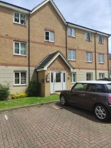 a car parked in front of a brick building at Immaculate 1-Bed Apartment in Borehamwood in Borehamwood