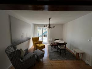 a living room with chairs and a dining room table at Gästehaus Melitta in Stadtkyll