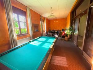 a pool table in the middle of a room at Villa Gorczańska in Rabka +44 photos