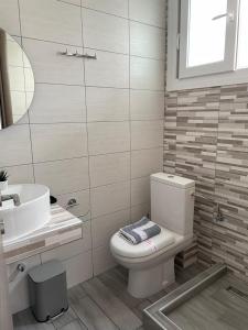 a bathroom with a toilet and a sink at Nigdeli Studios in Stavros