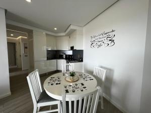 A television and/or entertainment centre at Ocean Garden Sunset Apartment - heated swimming pool Free WIFI