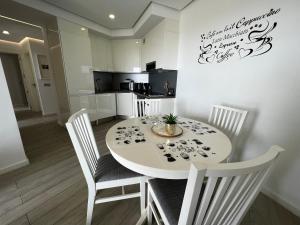 A television and/or entertainment centre at Ocean Garden Sunset Apartment - heated swimming pool Free WIFI