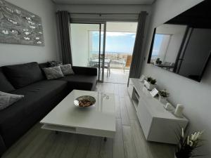 A seating area at Ocean Garden Sunset Apartment - heated swimming pool Free WIFI