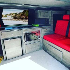 an interior of an rv with a couch and a tv at ChillDayz in Paignton