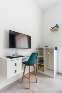 a desk with a green chair in a room at Blunotte Torino - Piazza Arbarello in Turin