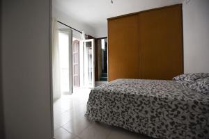 a bedroom with a bed and a large wooden headboard at Sète - LOFT 6 personnes. CENTRE VILLE / PORT in Sète