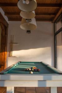 a pool table in a room with a light at Seuls en Pleine Nature - Gîte la Côte Blanche in Puygaillard-de-Quercy