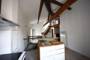 a kitchen with a wooden counter in a room at Sète - LOFT 6 personnes. CENTRE VILLE / PORT in Sète
