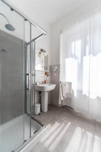 a bathroom with a glass shower and a sink at Blunotte Torino - Piazza Arbarello in Turin