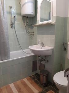 a bathroom with a sink and a toilet and a bath tub at apartman dobrinja2 in Sarajevo