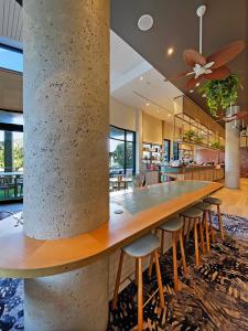 a large table in a kitchen with chairs around it at Seaside Stays Marcoola Beach Studio Room in Marcoola