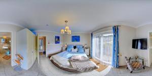 a bedroom with a large bed with blue pillows at Chalet am Waldsee direkt am Badesee Rieden mit Seeblick für bis zu 14 Personen Traumferienhaeuser-Eifel in Rieden +58 photos
