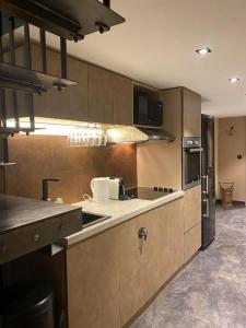a kitchen with a sink and a stove top oven at Bel Air - Propriétés Mont Amour in Montriond